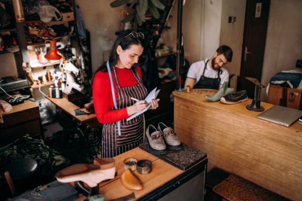 Shoemakers craft and design various footwear styles in a workshop, showcasing the evolution from classic to contemporary.